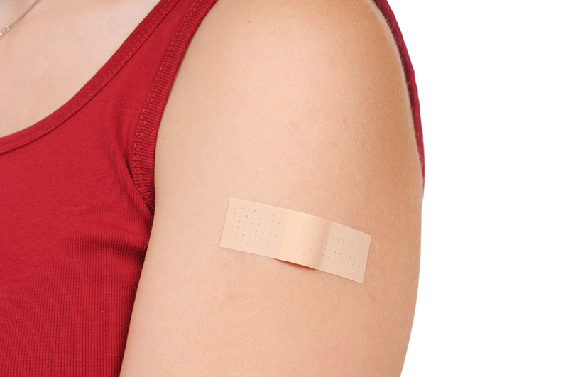 Person’s shoulder with a bandaid.