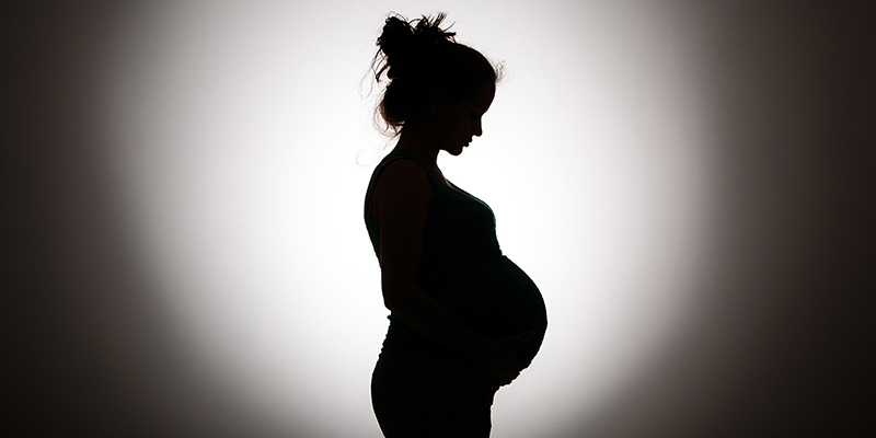 Silhouette of a pregnant person.