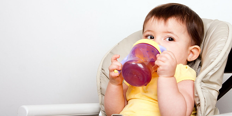 Toddler drinking from sippy cup.
