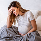 Pregnant woman appearing upset.