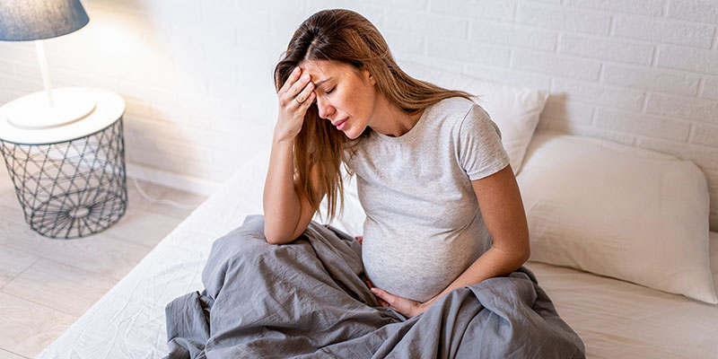 Pregnant woman appearing upset.