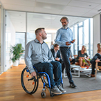 Person in wheelchair talking with medical professional.