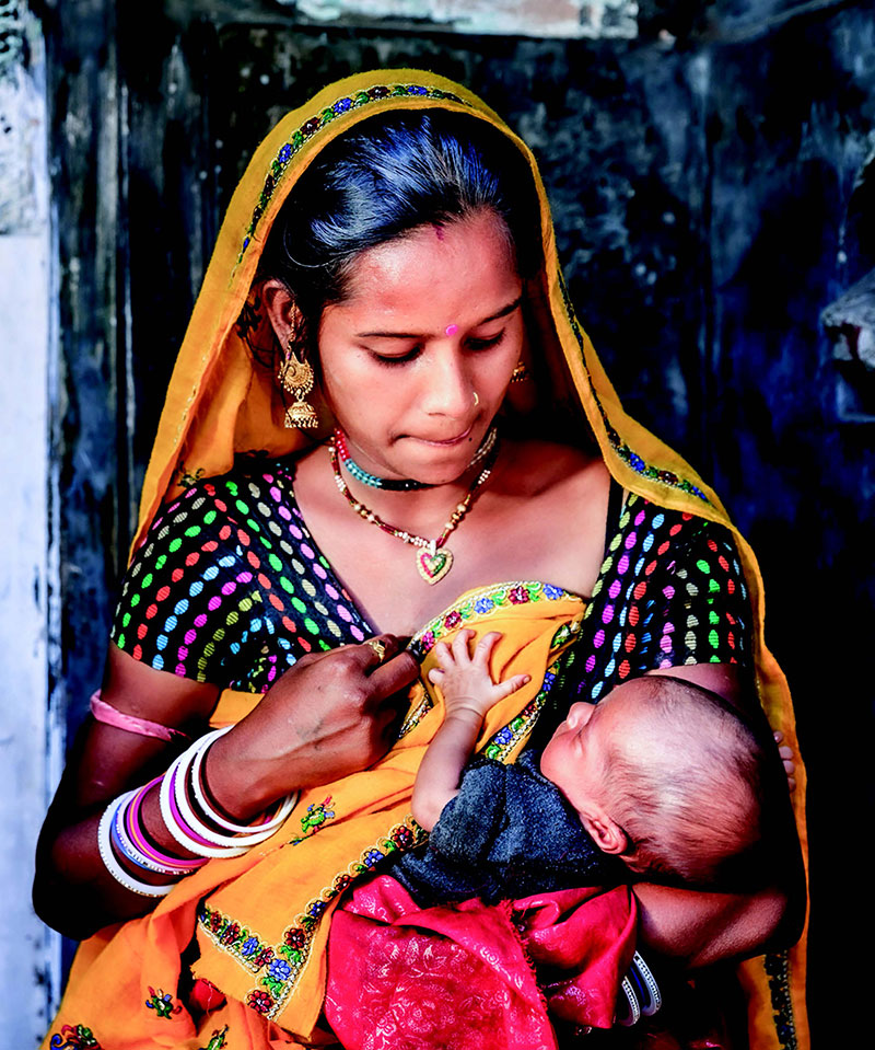 A mother holding her infant.