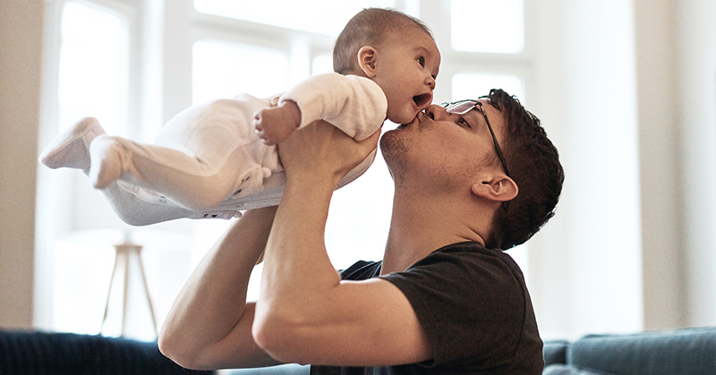 Father holding baby.