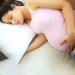 Pregnant person sleeping.