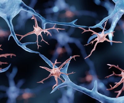 Illustration of brain cells in blue and pink against a black background.