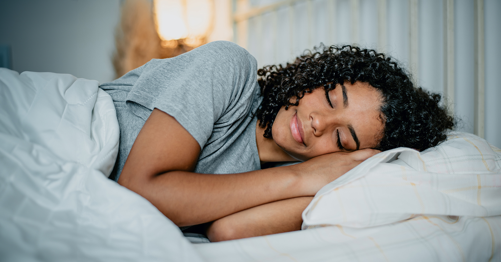 Teen sleeping in a bed.