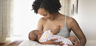 Woman breastfeeding infant.