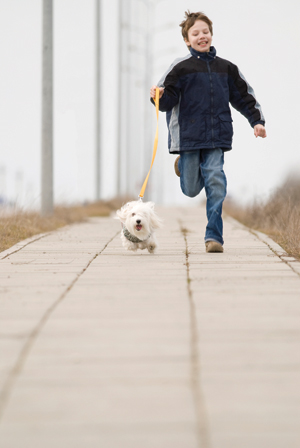 boy running with dog