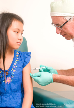 Young girl receiving vaccination.