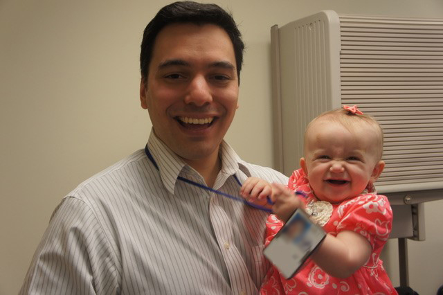 Dr. Ferreira holding Natalie in 2014.