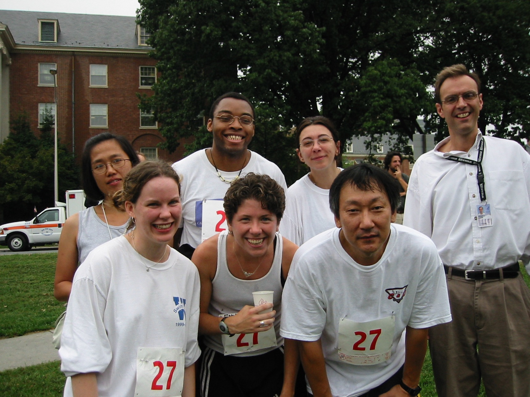 Members of the Levin lab, all in white shirts and some wearing race numbers, pose for a picture in 2002 after running the NIH relay race.