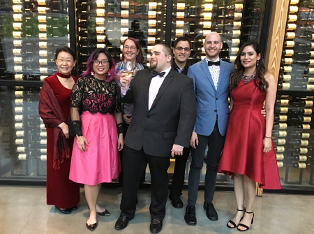 Lab members dressed in tuxedos and fancy dresses.
