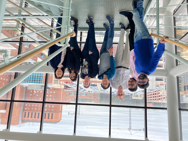 Lab members posing together in a stairwell.  
