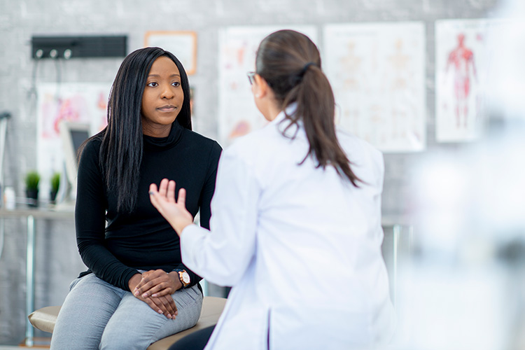 A patient and health care provider have a discussion.
