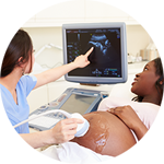 Radiologist showing ultrasound image to a pregnant woman
