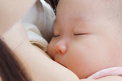 A mother breastfeeding her baby. 