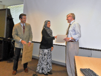 Shaking hands at graduation ceremony with Dr. Stratakis and colleague.