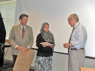 Fellow receiving diploma and speaking with Dr. Stratakis at ceremony.