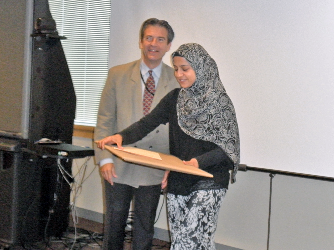 Dr. Stratakis handing award to fellow.