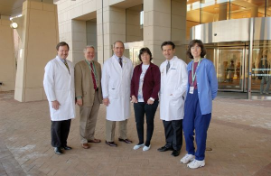 Group of 6 standing in front of Clinical Center.