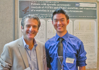 Dr. Stratakis and fellow standing in front of poster.