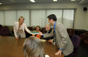 Shaking hands over the table.