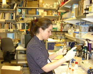 Isabelle Bourdeau pipetting in lab setting.