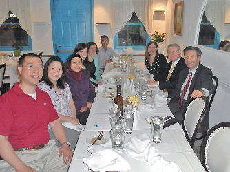 Dr. Stratakis sitting at a table at the graduation.