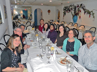 Dr. Stratakis and group of fellows sitting at a table in a restaurant.