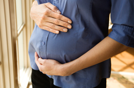 Pregnant woman holding belly