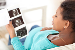 pregnant woman reviewing ultrasound scans