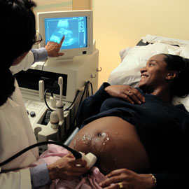 Pregnant woman viewing ultrasound