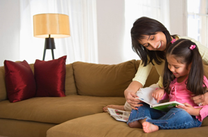 Mother and daughter reading a book.