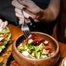 Woman eating salad.