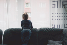 boy looking out window, stock photo