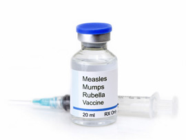 Bottle of measles, mumps, and rubella vaccine along with a hypodermic needle.