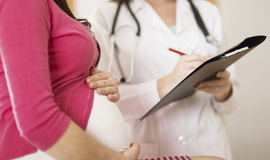 nurse taking information from a pregnant woman