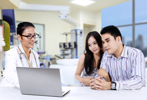 Couple being counseled by health provider.