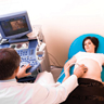 Woman receiving ultrasound in doctor's office.