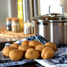 Potatoes next to cooking pot.