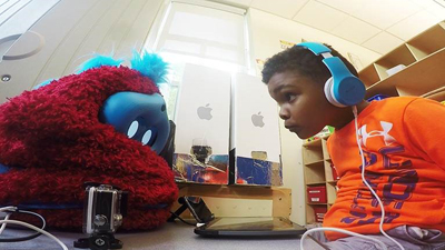 Preschooler interacts with a social robot companion.