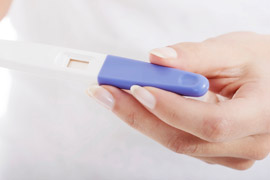 Woman holding a blank pregnancy test in her hand