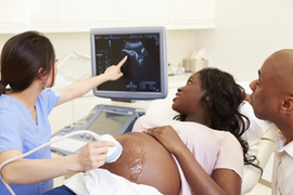 Pregnant woman and partner having 4d ultrasound scan