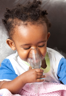 small child with inhalation mask