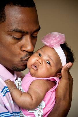 Father kissing daughter on cheek.