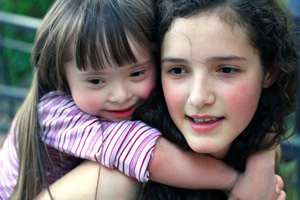 Two young girls playing and smiling