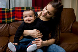 Boy sitting on his mother's lap