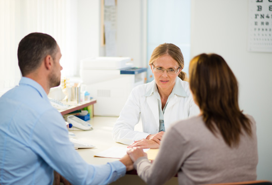 Stock image of couple and doctor