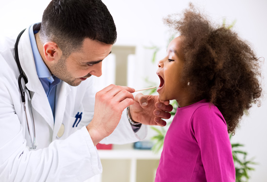 Stock image of doctor examining child